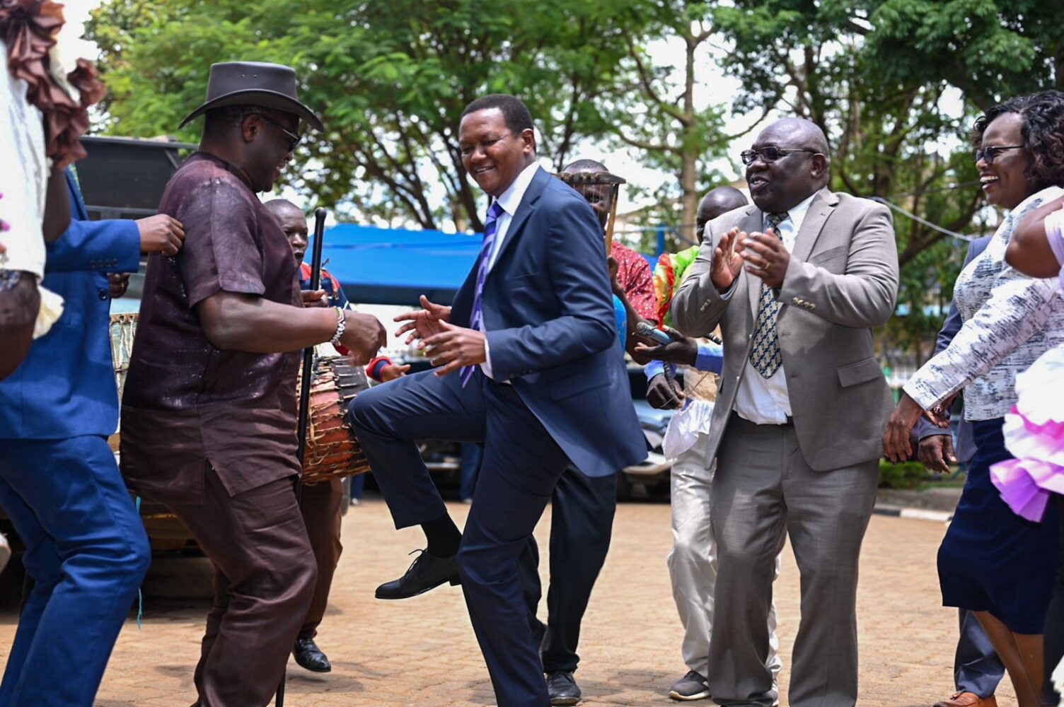 Tourism CS Alfred Mutua (C) with governor Kenneth Lusaka dancing Kamabeka with traditional Luhya dancers at Sang'alo cultural center in Bungoma on March 27, 2024. Photo: TV47. 