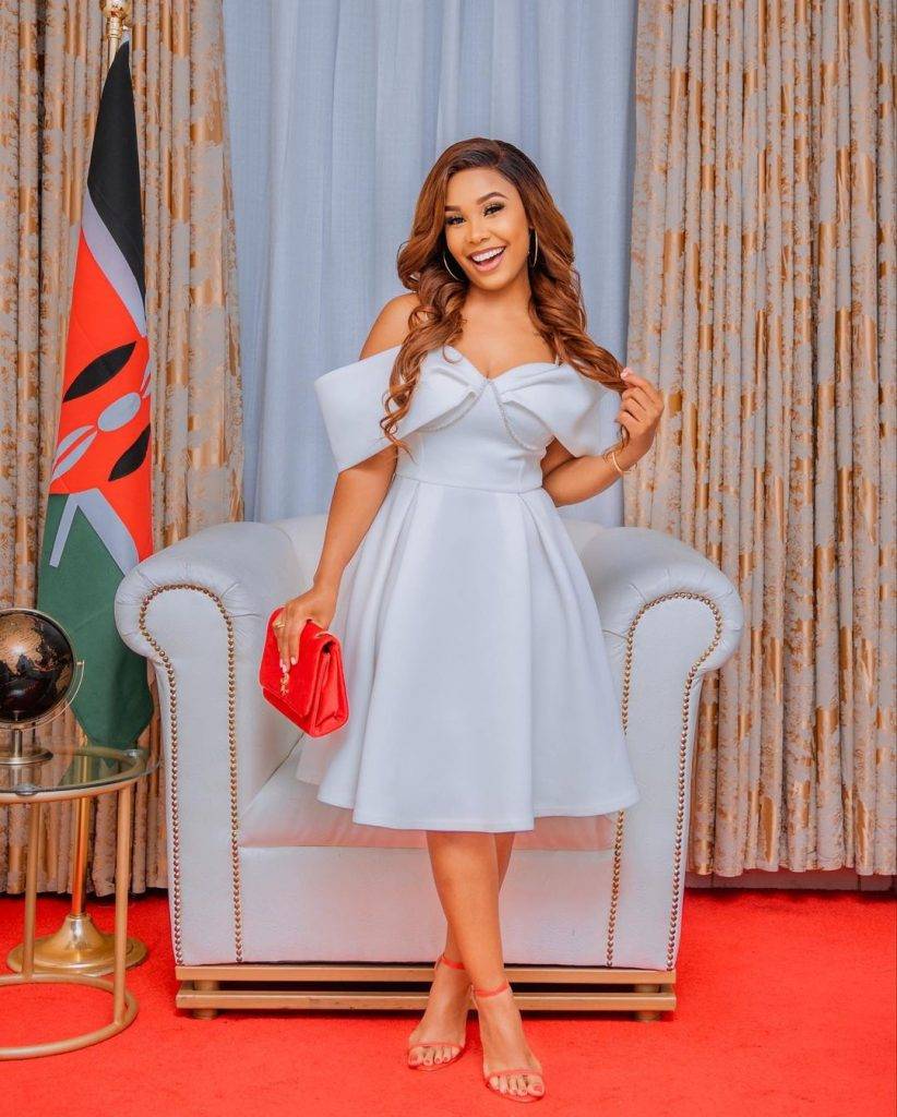 Phoina Tosha looking gorgeous and all smiles in her white outfit, matching shoes and clutch bag after a church service. Photo: Phoina/Instagram