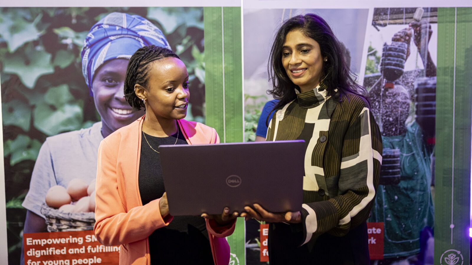 Ms. Michelle Gathigi (left) the Director of Operations for Spatial Collective Limited is taken through the application process of the Agribusiness Challenge Fund by the Mastercard Foundation Fund for Resilience and Prosperity Engagement Partner Mrs. Smita Sanghrajka (right) during the launch of the fund.
