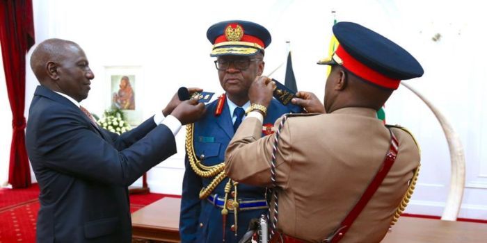 President Ruto (Left) helping outgoing CDF Robert Kibochi (Right) to don incoming Chief of Defence Forces General Francis Ogolla (Centre) after swearing-in ceremony at State House, Nairobi on April 29, 2023. PHOTO/ KDF