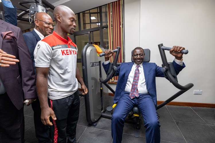 President William Ruto tries gym equipment at the newly opened Bunger Tower on April 25, 2024. Photo: PCS 