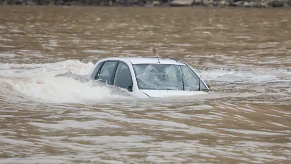 Car swept by floods.